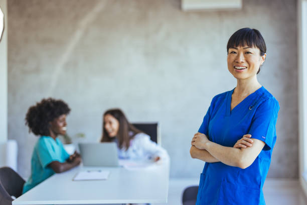 istock Confident Nurse Standing with Colleagues in Medical Office 2172801559