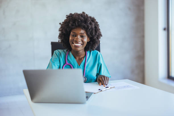 istock Smiling Medical Professional Working on Laptop in Office Setting 2172801716