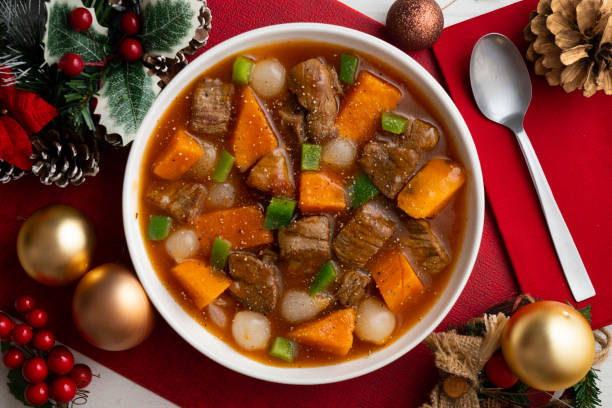 istock Beef stew with pumpkin and green beans. Top view table with Christmas decoration. 2172803305