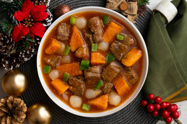 istock Beef stew with pumpkin and green beans. Top view table with Christmas decoration. 2172803331