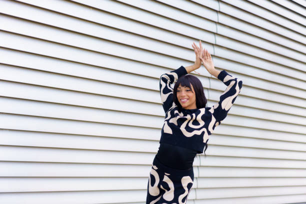istock Happy dancer raising hands posing on the street 2172804886