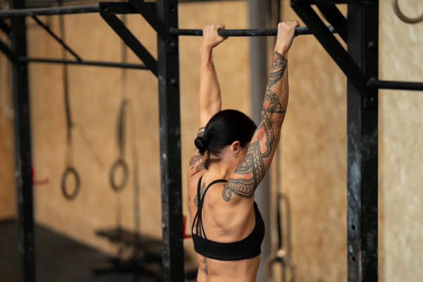 istock Sportive mature woman doing pull ups in the gym 2172805027
