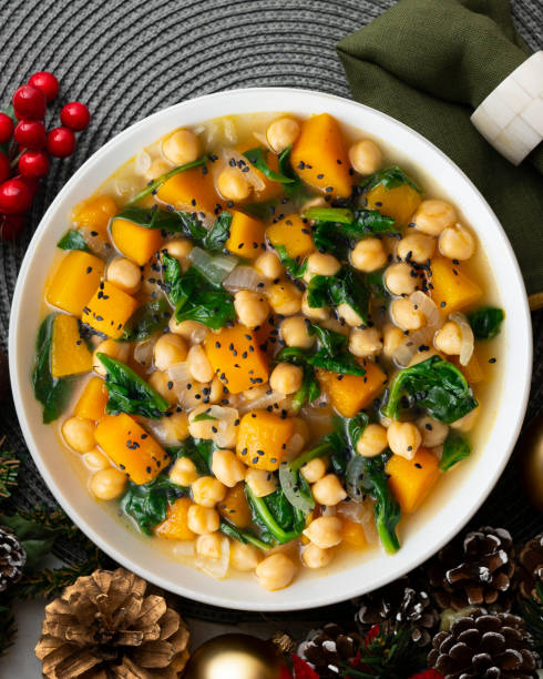 istock Chickpea stew with pumpkin and spinach. Top view table with Christmas decoration. 2172805336
