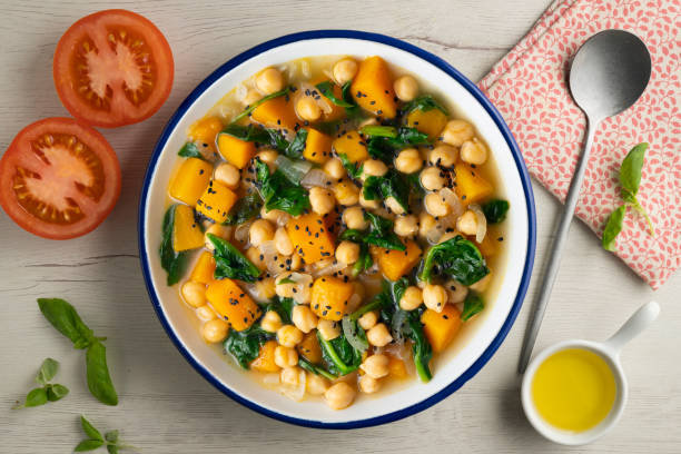 istock Chickpea stew with pumpkin and spinach. Top view table with decoration. 2172805379