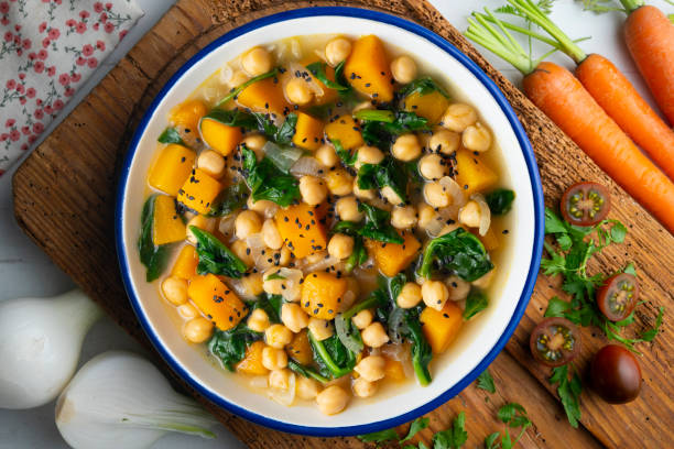istock Chickpea stew with pumpkin and spinach. Top view table with decoration. 2172805388