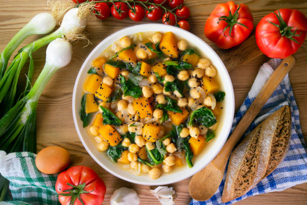 istock Chickpea stew with pumpkin and spinach. Top view table with decoration. 2172805403