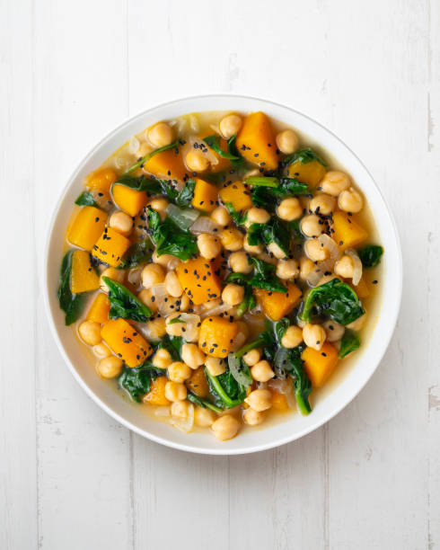 istock Chickpea stew with pumpkin and spinach. Top view table with decoration. 2172805406