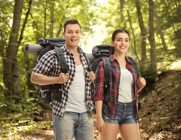 istock Young couple hikers with backpacks 2172807005