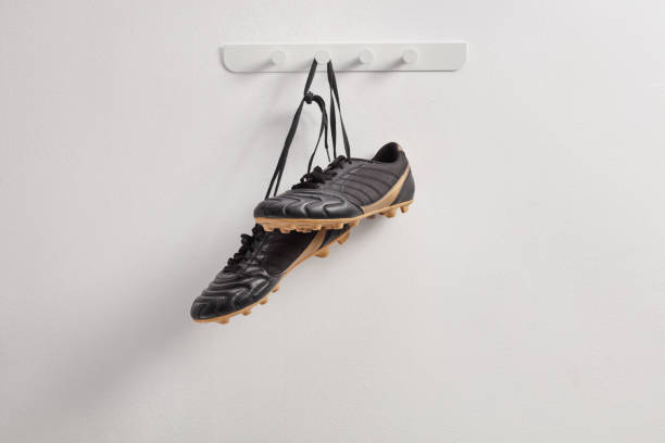 istock Black football cleats hanging 2172807792