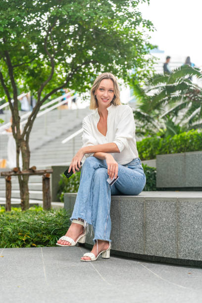 istock Woman Using Smartphone and Credit Card for Online Payment Outdoors, Looking at Camera 2172808861
