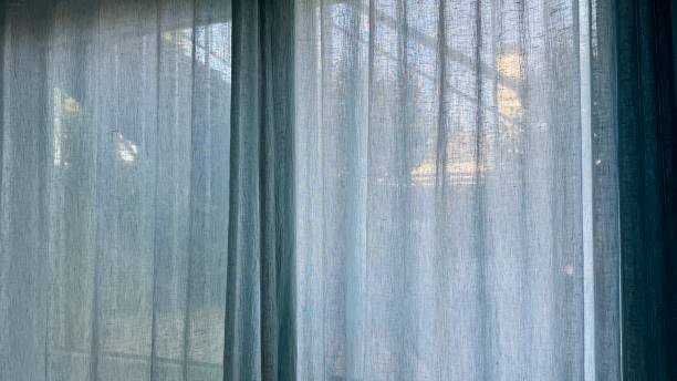 istock View outside through the blue curtain 2172810327