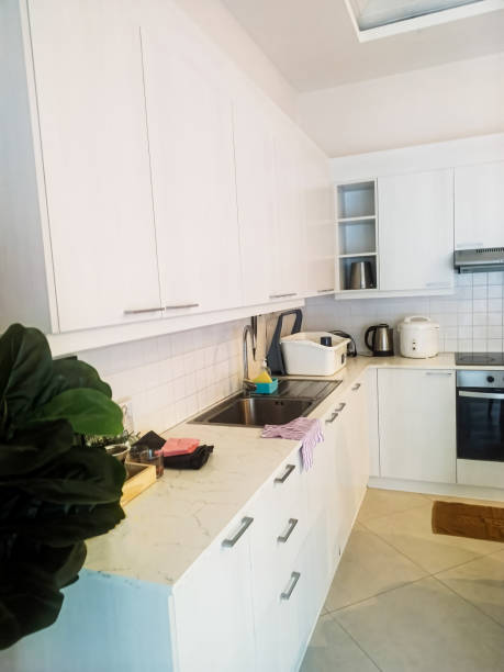 istock Vertical image showing the atmosphere in a modern wall-mounted kitchen that emphasizes simple functionality but is compact and beautiful, Chiang Mai, Thailand. 2172810820