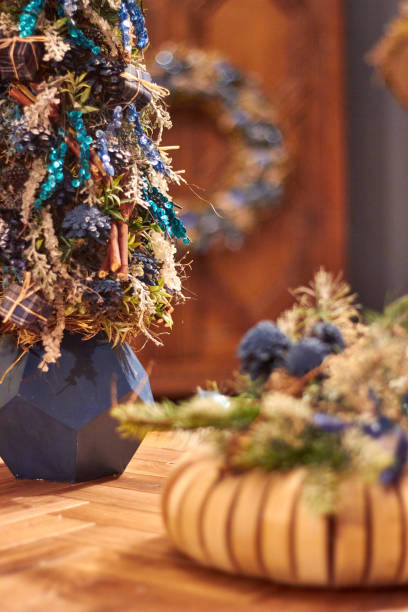 istock decorated Christmas tree in blue colors on a wooden table in the interior 2172812424