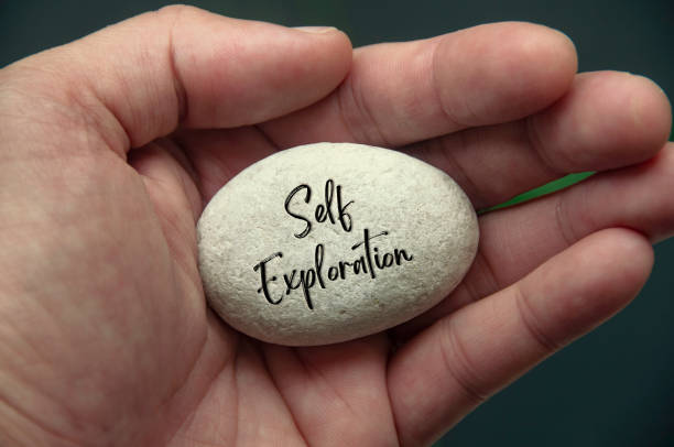 istock Hand holding Zen stone with Self Exploration text engraved on the stone 2172814063