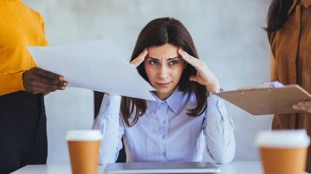 istock Stressed Businesswoman Overwhelmed by Work in Office Environment 2172815896