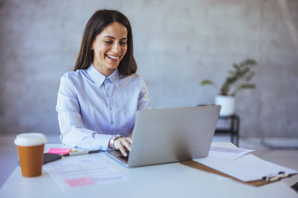 istock Smiling Professional Woman Working On Laptop in Modern Office 2172815975