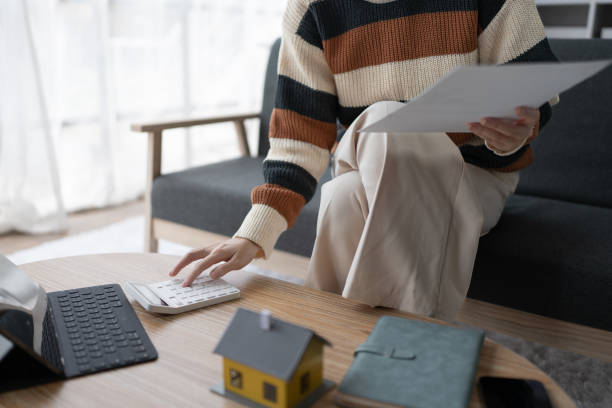 istock Smart Mortgage Planning woman using a calculator to make Calculations and Consideration 2172816636