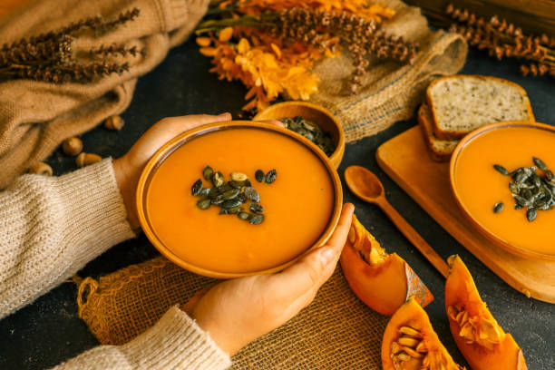 istock Pumpkin soup in hands, autumn cozy mood 2172817423
