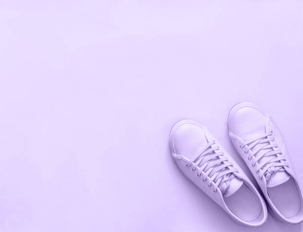 istock violet sneakers on violet background, copy space 2172819039