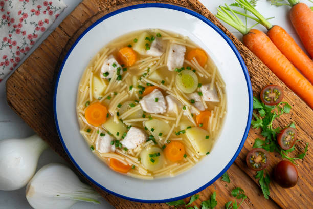 istock Fish, noodle and vegetable soup. Top view table with  decoration. 2172820651