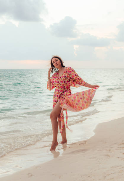istock Woman on the beach at sunset 2172824434