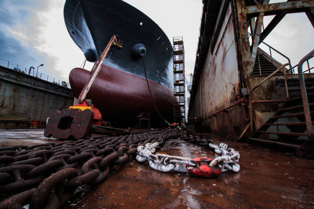 Dubrovnik. Croatia - October 23, 2025: An anonymous maritime laborer in personal protective equipment (PPE) performs maintenance tasks on a docked vessel. Concept of industrial labor, logistics