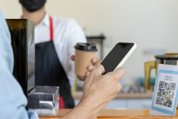 istock man use smartphone to scan QR code to pay in cafe restaurant with a digital payment without cash. Choose menu and order accumulate discount. E wallet, technology, pay online, credit card, bank app. 2172832741
