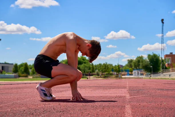 istock Exhausted athlete crouching on track after intense workout 2172833039
