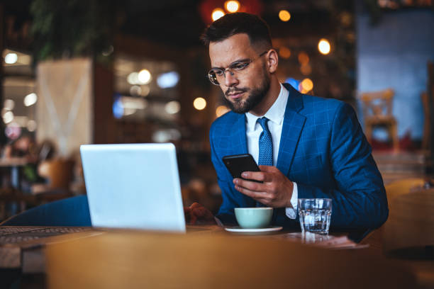 istock Businessman Working Remotely at Cafe Using Laptop and Smartphone 2172837852