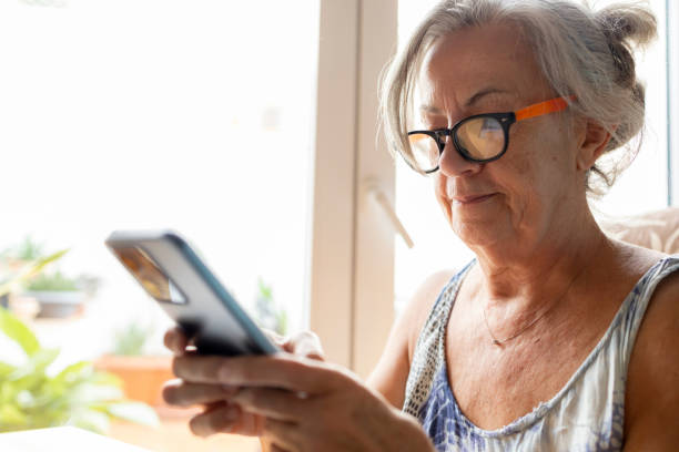 istock Senior woman using smartphone while wearing glasses 2172838469