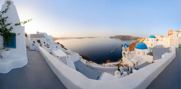 traditional greek village Oia of Santorini, with blue domes against Aegan sea and caldera, Greece, web banner format