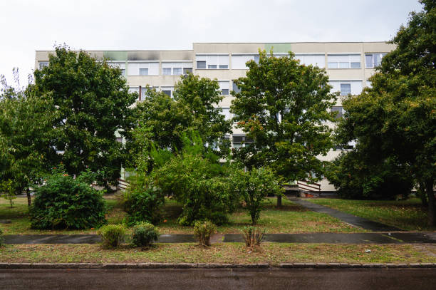 istock Apartment building with green trees in front 2172843360