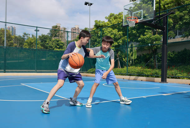 istock Two boys playing basketball 2172844002