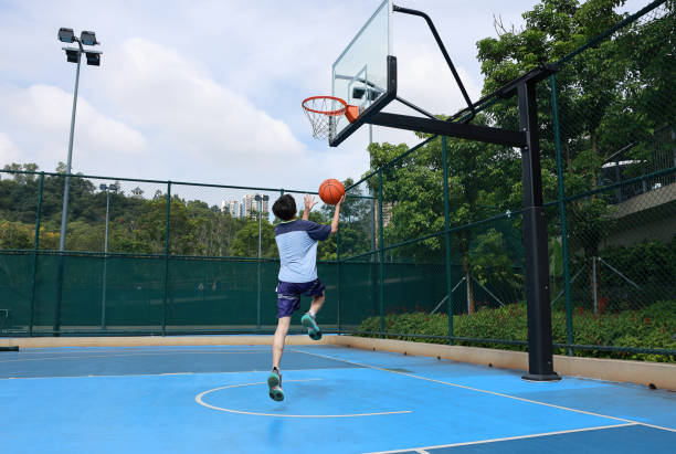 istock Cute Asian boy playing basketball 2172844035