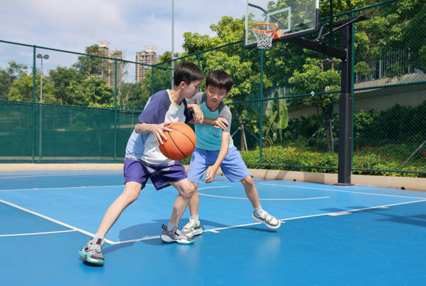 istock Two boys playing basketball 2172844042