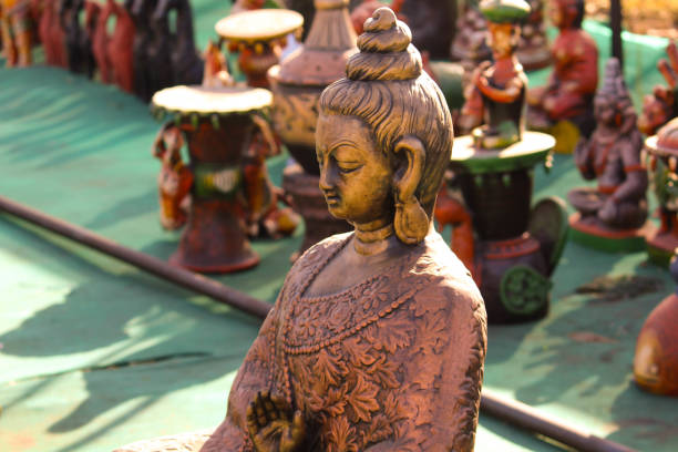 decorative Lord Buddha Sculpture  Made with Earthen Mud, handcrafted traditional clay decoration toy in Indian market, handmade Items of Earthenware Or Ceramic at a Vendor Stall