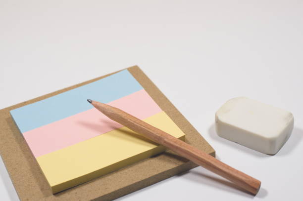 istock Post-it notes, an eraser, and a pencil are all-purpose tools for jotting down ideas and making calculations. 2172848228