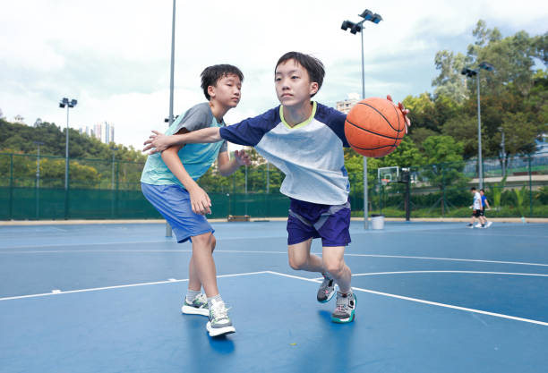 istock Two boys playing basketball 2172850364