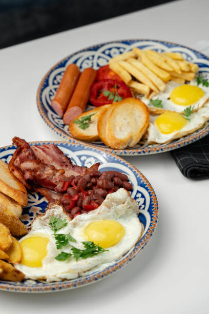 istock Two plates of a hearty breakfast served on decorative bowls 2172851643