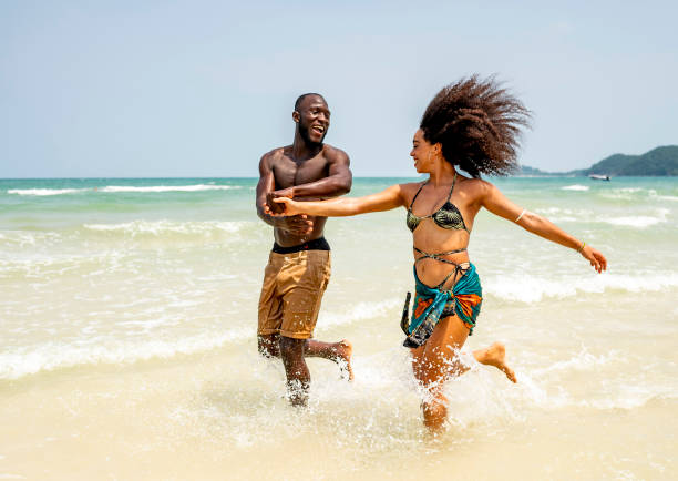 istock Joyful Couple Running on Sunny Beach Vacation 2172851662