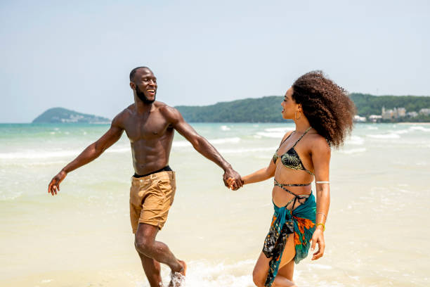 istock Joyful Couple Holding Hands During Beach Vacation 2172851696