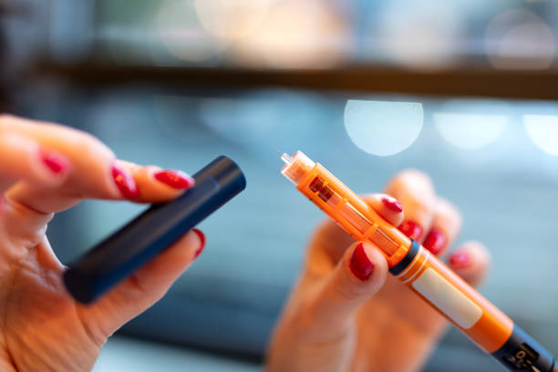 Woman holding an injection pen for diabetic