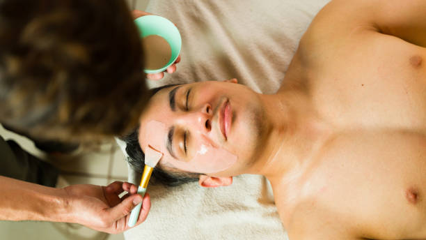 istock Happy and relaxed Hispanic man getting a beauty mask after a massage at a spa 2172856098