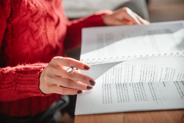 Summer reading: Female hands holding pink book