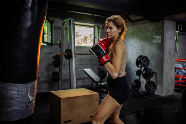 istock Fierce boxing training by woman in modern gym 2172859980