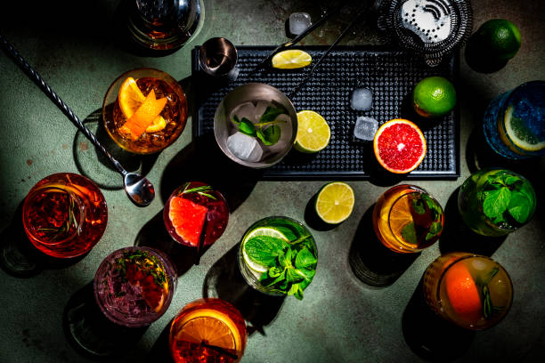 istock Alcoholic cocktails and bar tools on green background, top view 2172860203