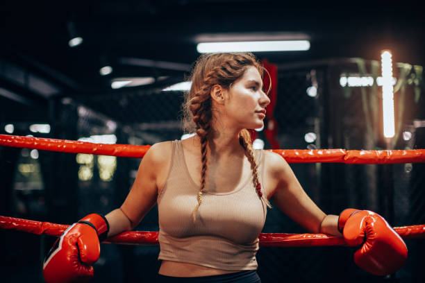 istock Focused boxer leans against ropes in boxing ring. 2172861001