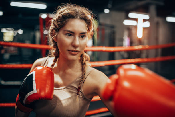 istock Focused female athlete practices boxing skills 2172861779