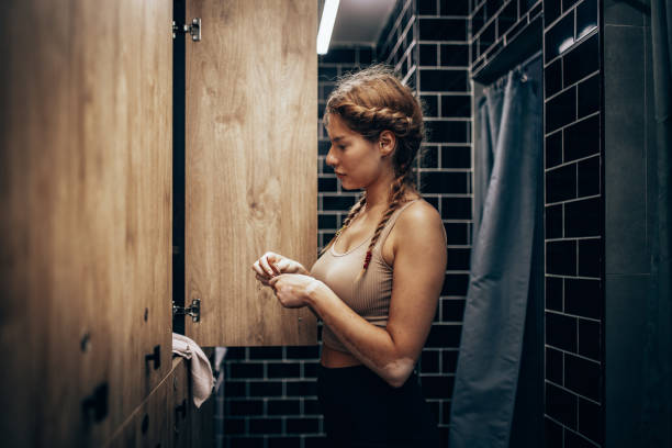 istock Athlete securing locker, holding towel and gloves 2172863291