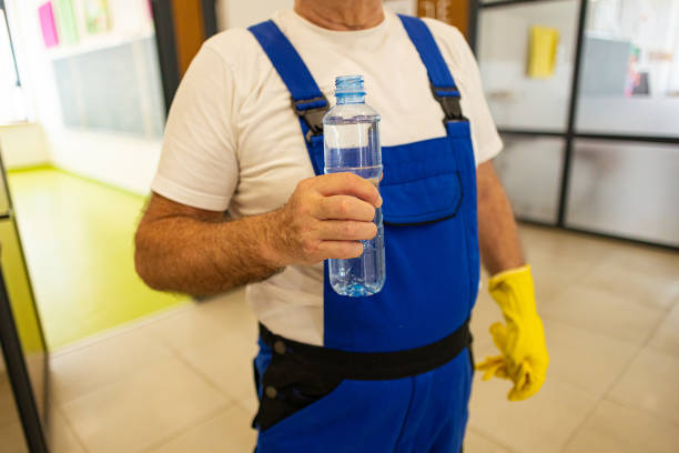 istock Male senior janitor holding plastic water bottle 2172863607